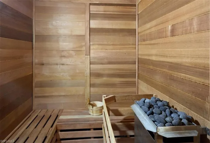 Relaxing sauna featuring wooden walls