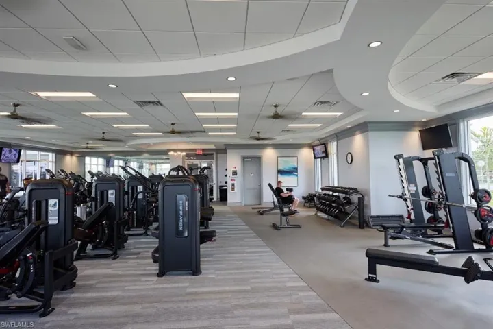 Exercise room with a drop ceiling and carpet