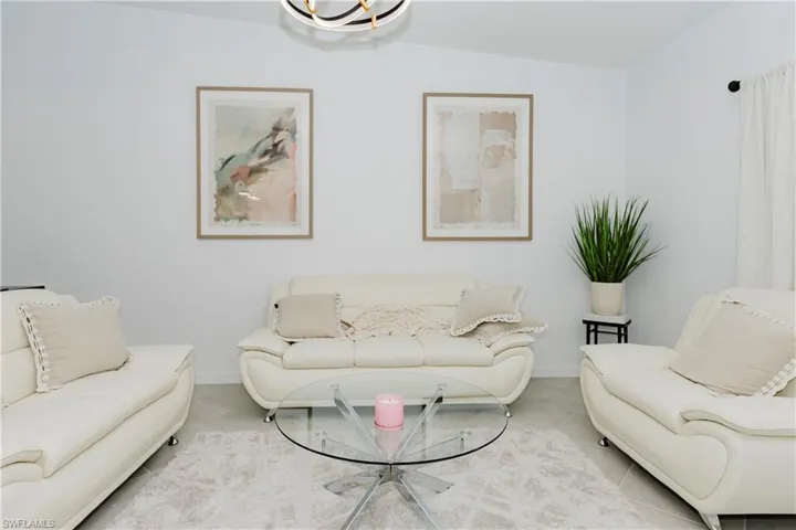 Living area with baseboards and tile patterned floors