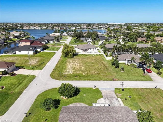 Aerial overview of property's location with nearby suburban area and a nearby body of water