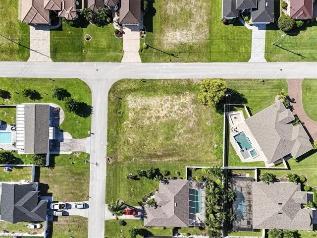 Aerial perspective of suburban area with a pool