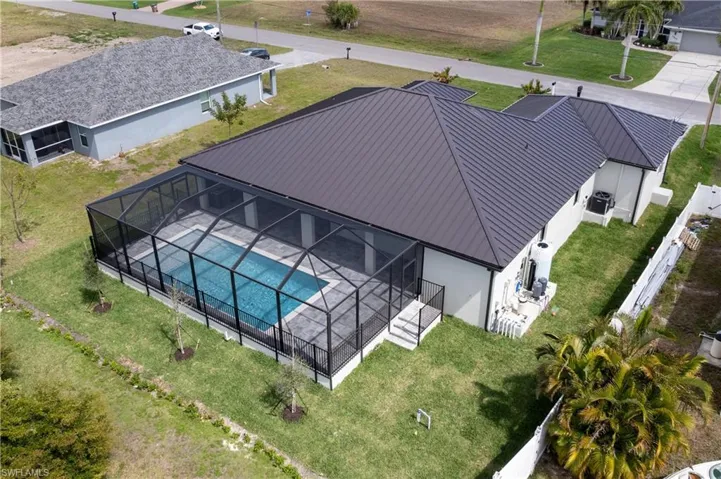Designed for MODERN FLORIDA LIVING, this CONTEMPORARY LUXURY HOME features SCREENED SALTWATER POOL, perfect for year-round enjoyment!