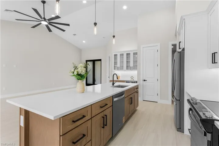 GORGEOUS CHEF'S KITCHEN w/ SPACIOUS QUARTS COUNTERTOP ISLAND w/ undermount LARGE SINK & SLEEK MATTE-BLACK gooseneck FAUCET.