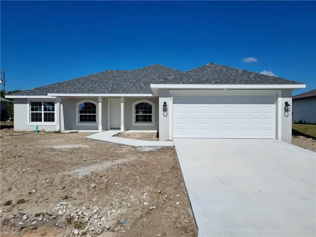 Ranch-style home with stucco siding, a shingled roof, covered porch, driveway, and an attached garage