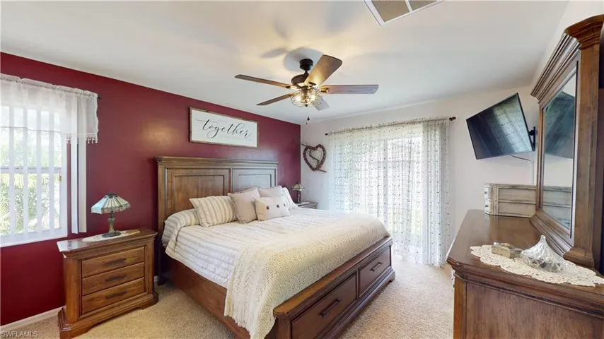 Carpeted bedroom with ceiling fan