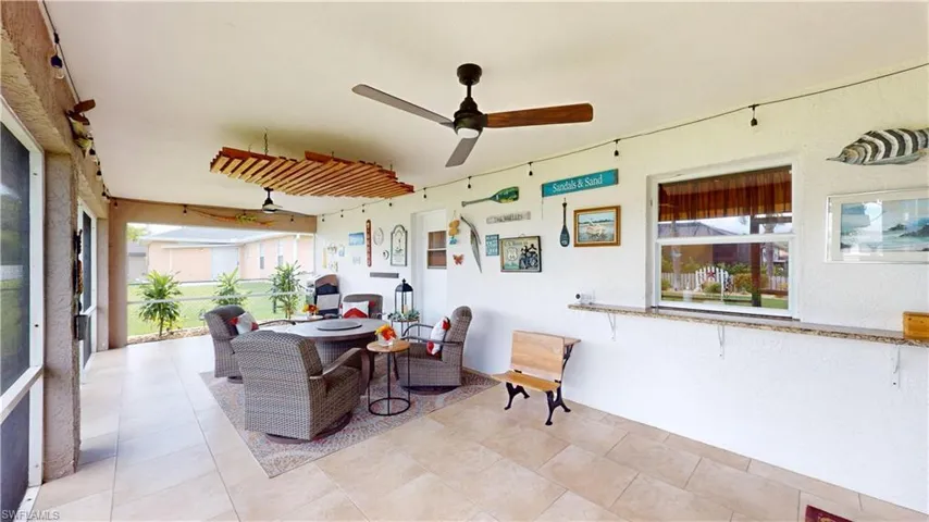 Sunroom / solarium featuring ceiling fan