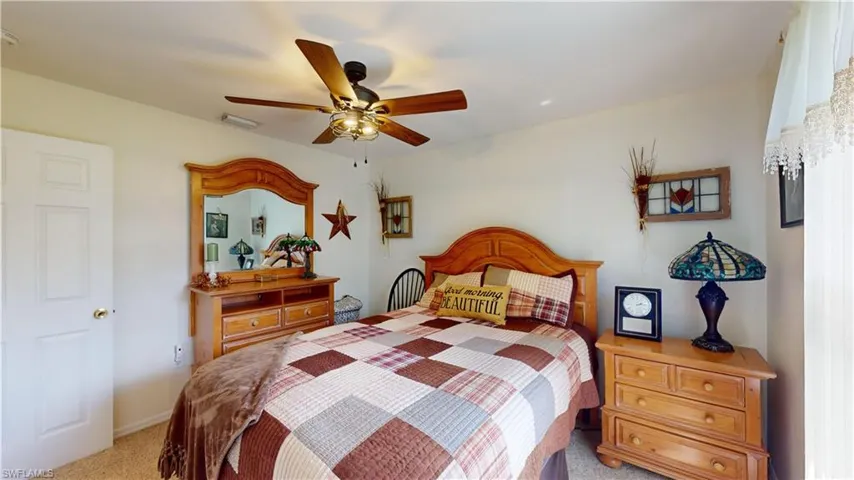Carpeted bedroom with ceiling fan