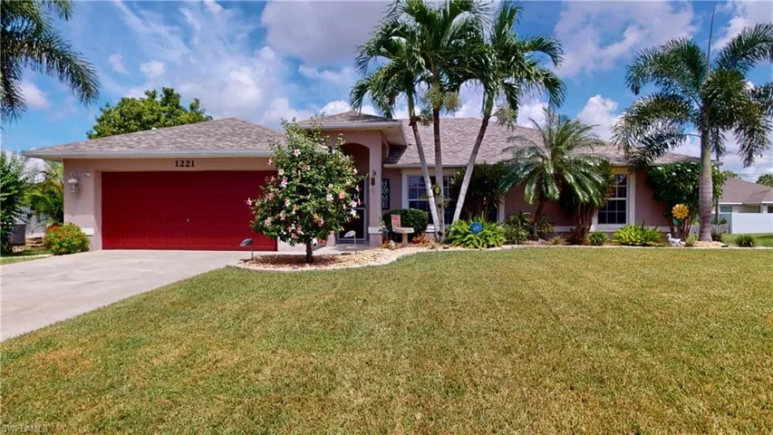 View of front facade with a garage and a front lawn