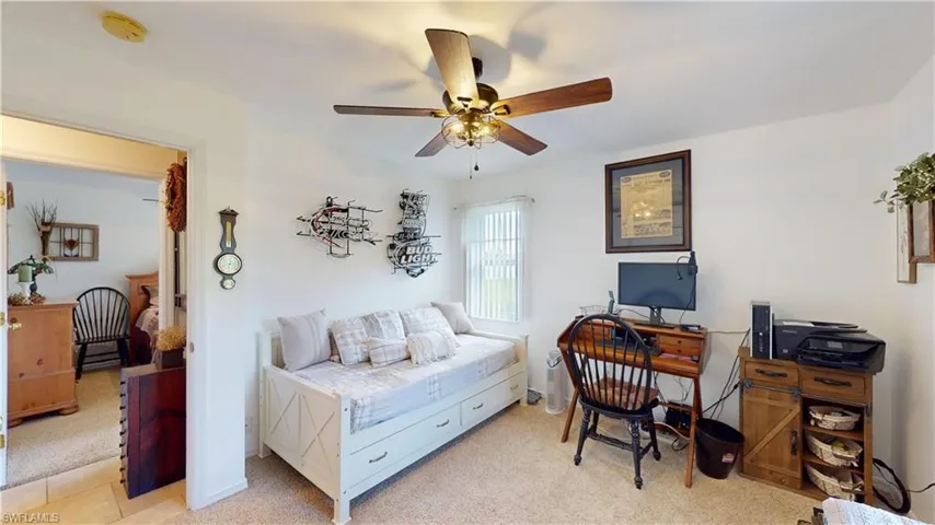Carpeted bedroom featuring ceiling fan