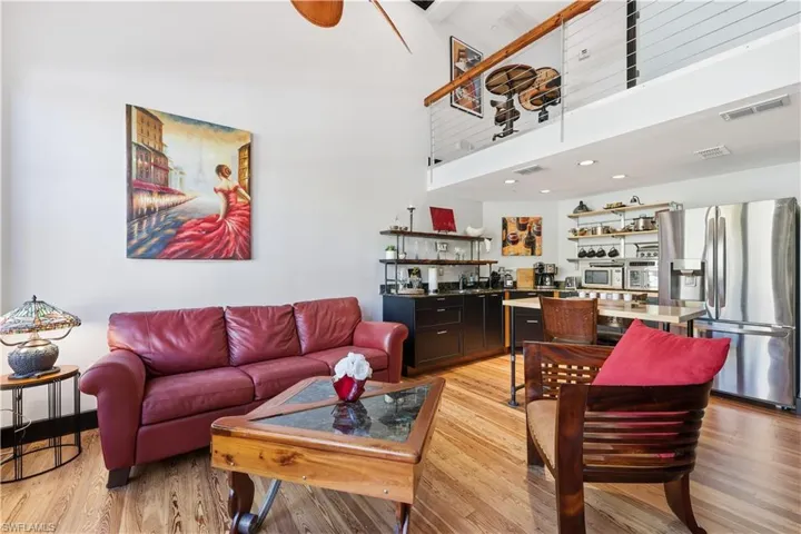 Living room featuring a towering ceiling and light wood-type flooring