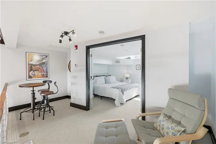 Upstairs Master Bedroom featuring light colored carpet and baseboards