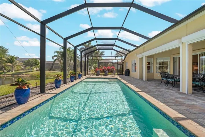 Outdoor pool with glass enclosure and a patio