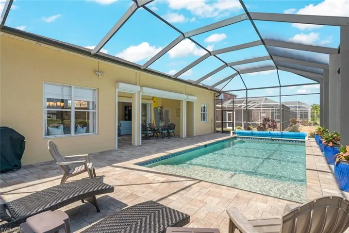 View of pool featuring grilling area, a covered pool, and a patio area