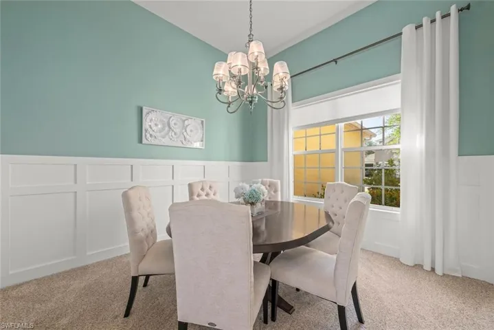 Dining room featuring a chandelier and carpet