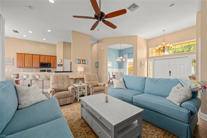 Living room with arched walkways, recessed lighting,