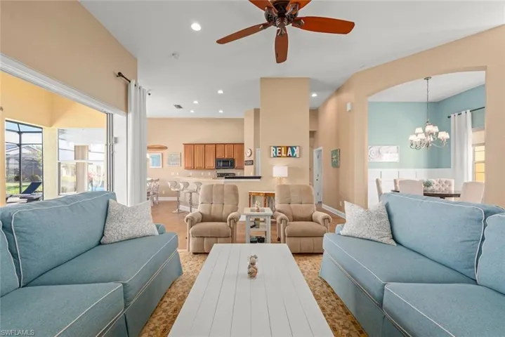 Living room with arched walkways, recessed lighting