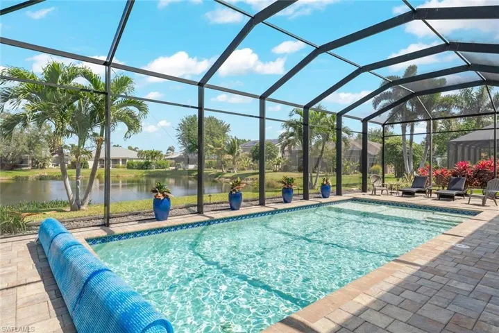 Pool featuring a lanai, a patio, and a water view