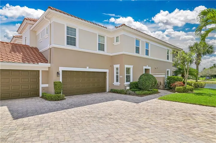 Mediterranean / spanish home with decorative driveway, a tile roof, stucco siding, and a garage