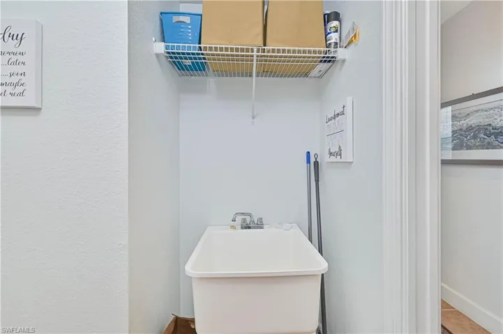 Laundry room featuring a textured wall