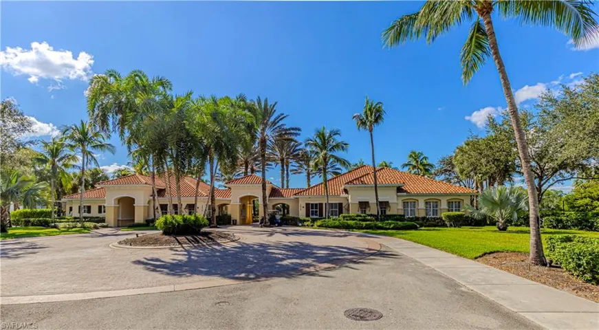Mediterranean / spanish-style house featuring stucco siding, a tiled roof, and curved driveway