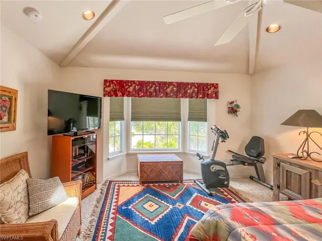 Carpeted bedroom featuring a ceiling fan, recessed lighting, vaulted ceiling, and baseboards