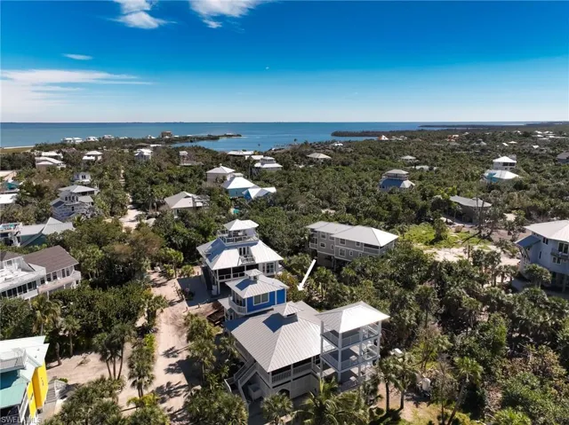 Birds eye view of property with a water view