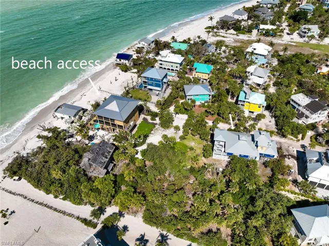 Aerial view with a water view and a view of the beach