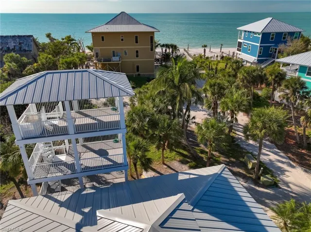 Drone / aerial view featuring a water view and a view of the beach