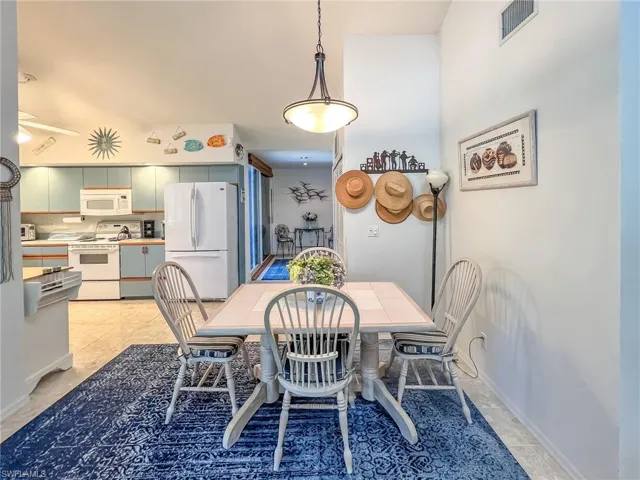 Dining area featuring visible vents and baseboards