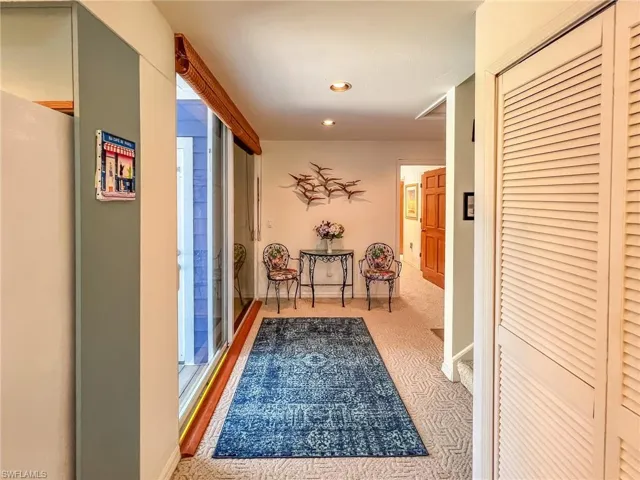 Hallway featuring carpet floors, recessed lighting, and baseboards