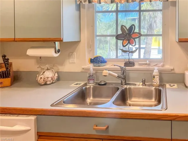 Interior details featuring dishwasher, light countertops, and a sink
