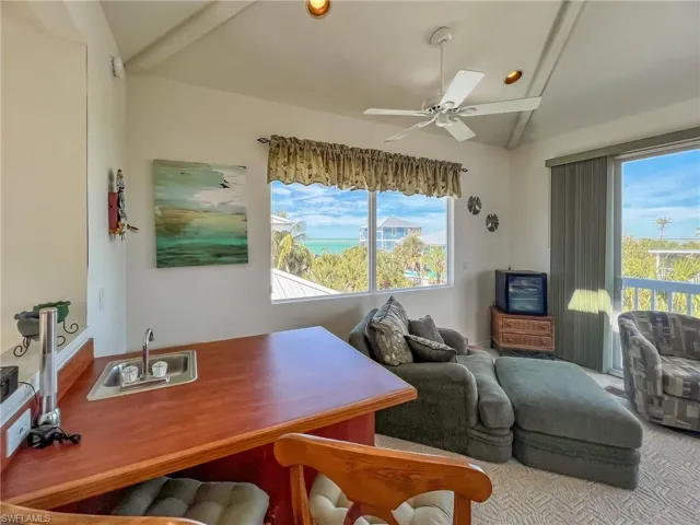 Home office featuring vaulted ceiling and ceiling fan