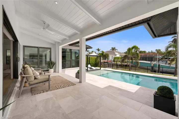 View of pool with a patio area, ceiling fan, fence, and a fenced in pool