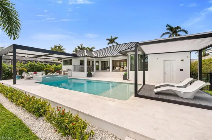 View of swimming pool featuring a patio area and a pool with connected hot tub