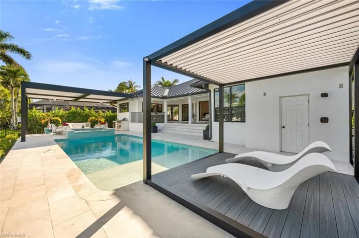 View of pool with a pool with connected hot tub and a patio