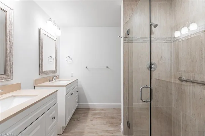 Bathroom featuring vanity, hardwood / wood-style floors, and walk in shower