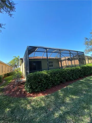 Landscaped backyard and sideyard looking toward screened lanai