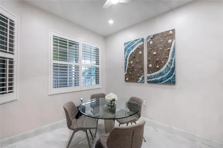 Dining space featuring a ceiling fan, recessed lighting, marble finish floor, and baseboards