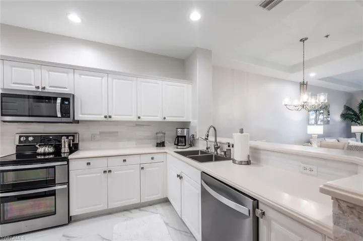 Kitchen featuring visible vents, appliances with stainless steel finishes, marble finish floor, a sink, and recessed lighting