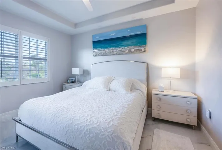 Bedroom with ceiling fan and baseboards