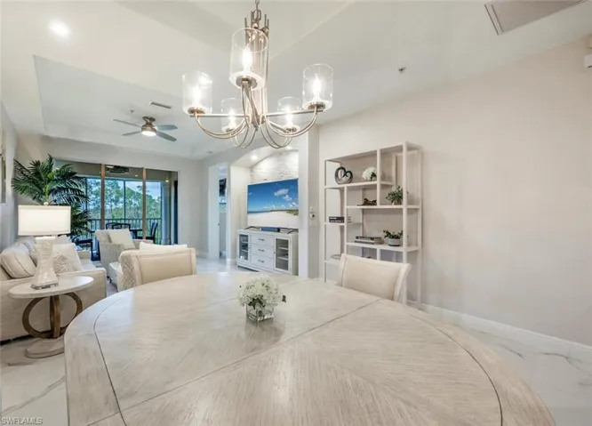 Dining room with marble finish floor, baseboards, visible vents, and a ceiling fan