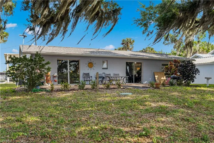 Back of house featuring a yard