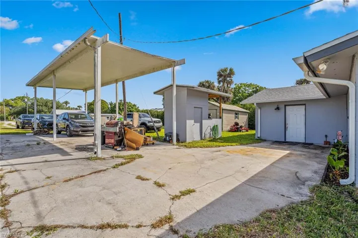 View of patio / terrace with a carport and concrete driveway