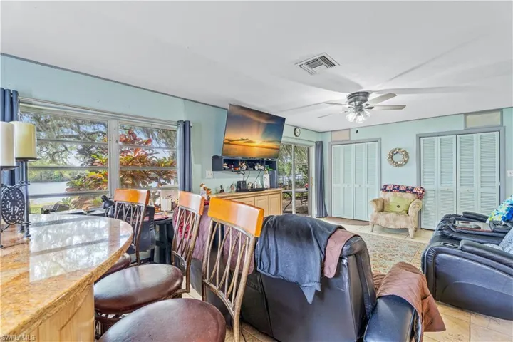 Living area with visible vents and ceiling fan