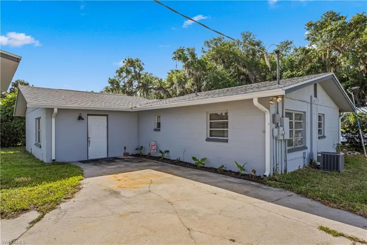 Single story home featuring roof with shingles, central AC, and concrete driveway