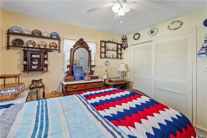 Bedroom featuring ceiling fan and a closet