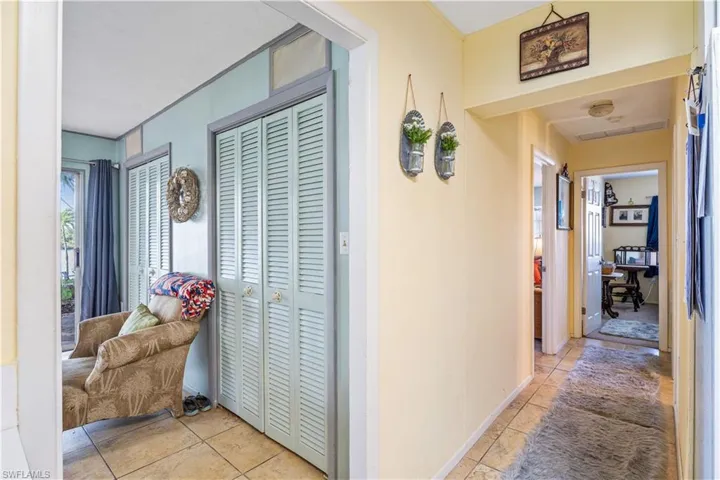 Corridor featuring light tile patterned floors