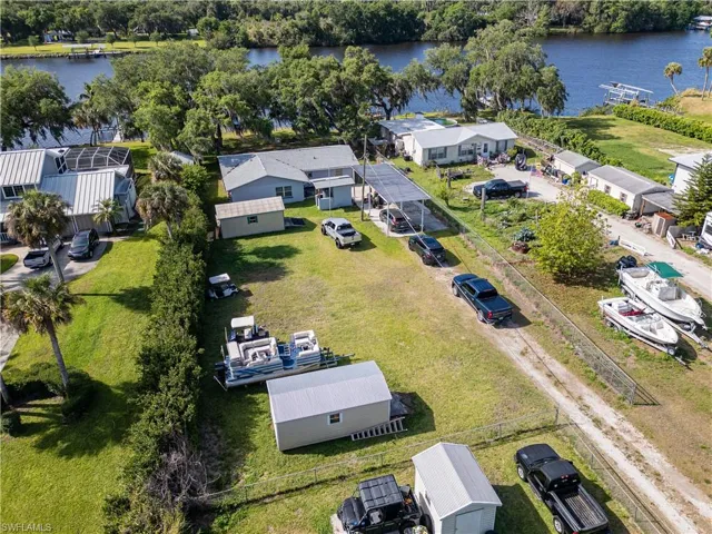 Birds eye view of property with a water view and a residential view