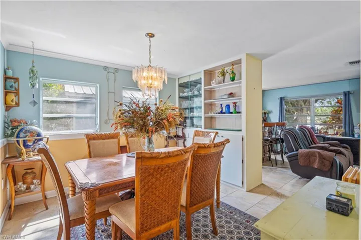 Dining space with plenty of natural light and an inviting chandelier