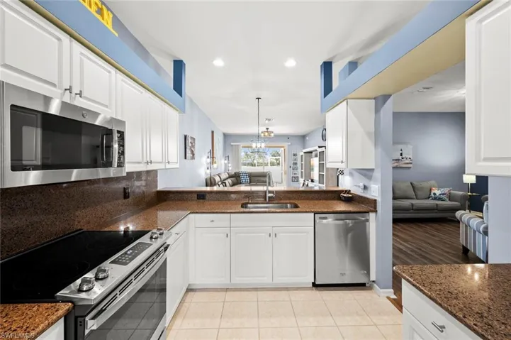 Kitchen w/granite counters, bright white cabinets